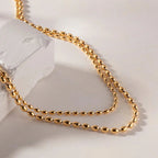 Collier superposé de perles dorées 18k
