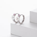 Boucles d'oreilles pendantes pour femme avec design floral et accents en zircon