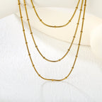 Collier multicouche pour femme avec pendentif perle et chaîne élégante