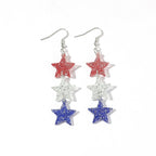 Boucles d'oreilles longues étoile en résine pailletée