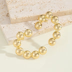 Bracelet pour femme avec perles dorées texturées