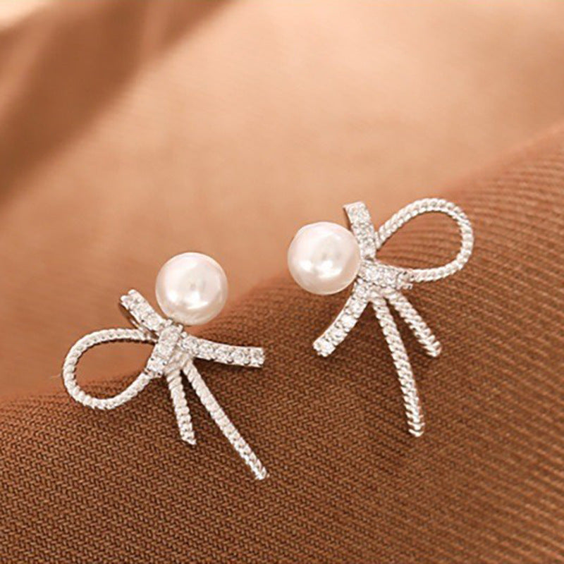 Boucles d'oreilles pour femme au design nœud et perles scintillantes