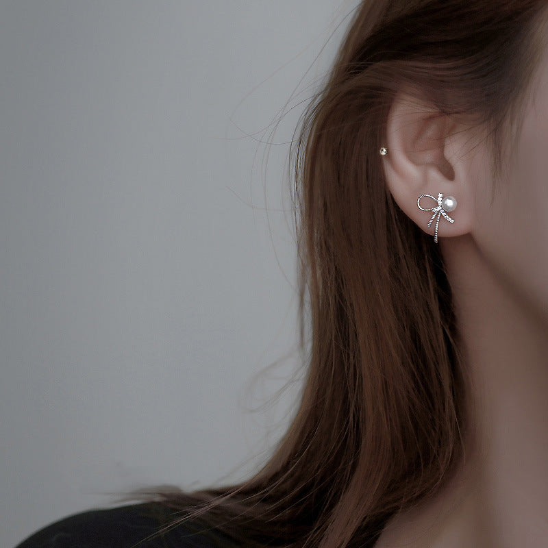 Boucles d'oreilles pour femme au design nœud et perles scintillantes