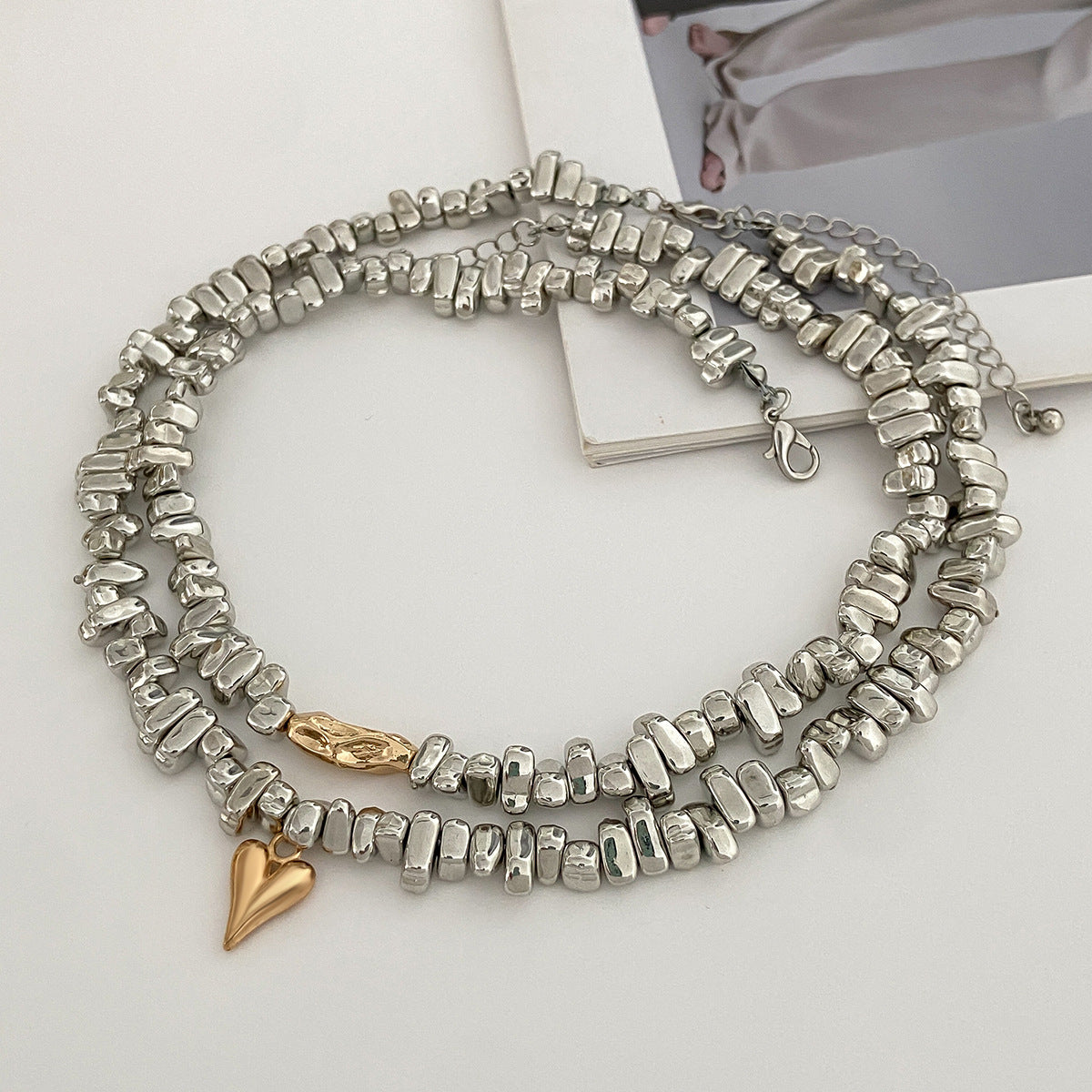 Collier élégant pour femme avec perles asymétriques et accents métalliques