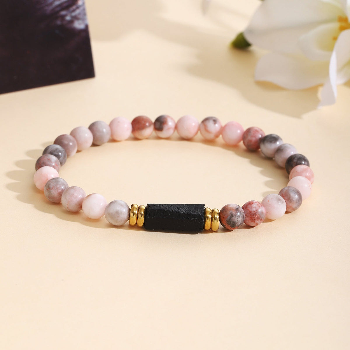 Bracelet pour femme en quartz rose avec accents noirs et dorés
