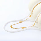 Collier multicouche pour femme avec perles délicates et pendentifs nœuds