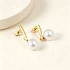 Boucles d'oreilles pendantes pour femme avec perle et finition dorée