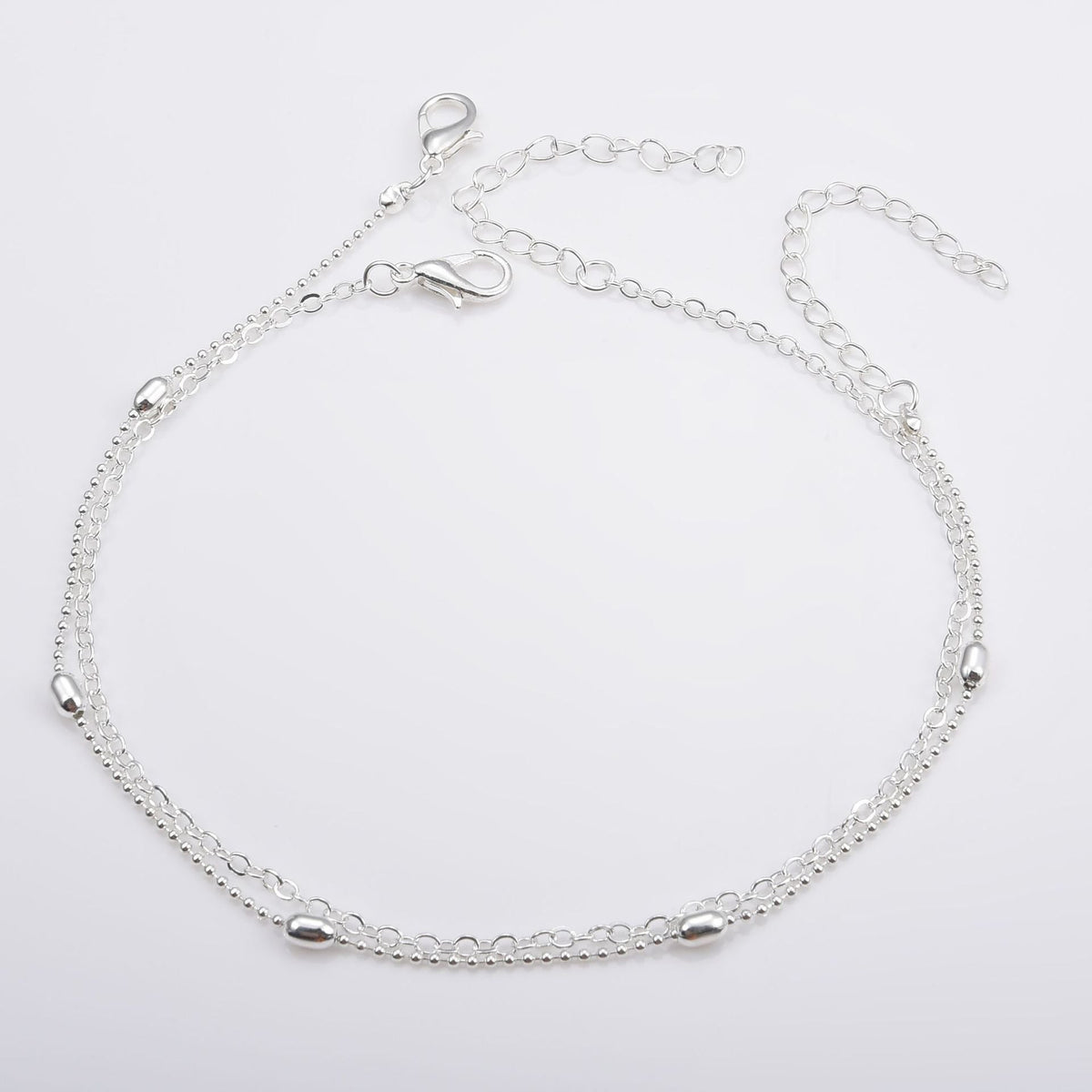 Bracelet de cheville délicat à chaînes superposées