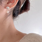 Damen Ohrhänger mit eleganten Muschel-Design und schimmernden Perlen