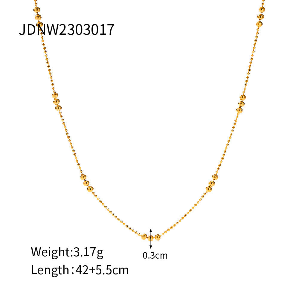 Collier pour femme avec perles et détails sphériques
