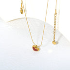 Collier pour femmes avec pendentif croix étincelant en acier inoxydable doré