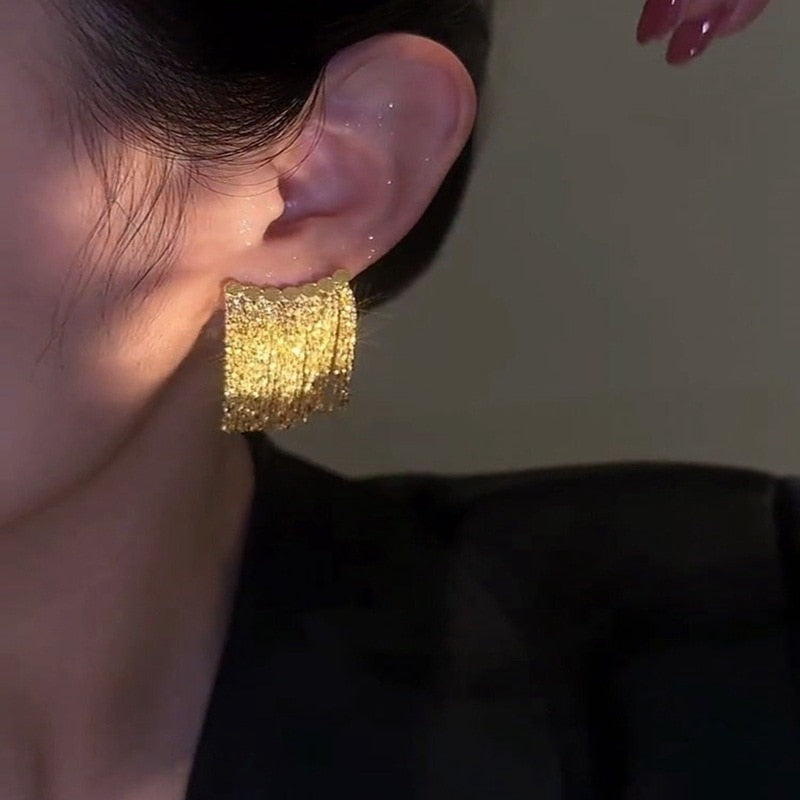 Boucles d'oreilles à pompons dorés