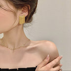 Boucles d'oreilles à pompons dorés