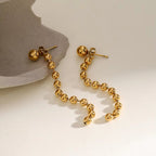 Boucles d'oreilles pompons perles dorées