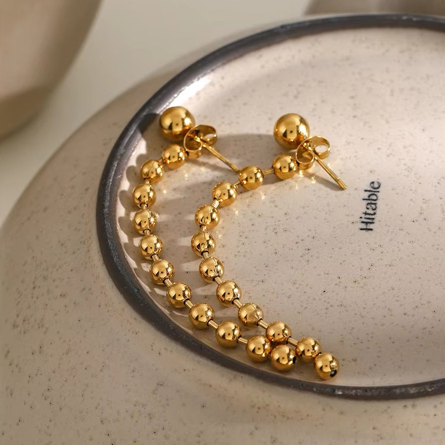 Boucles d'oreilles pompons perles dorées