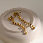 Boucles d'oreilles pompons perles dorées