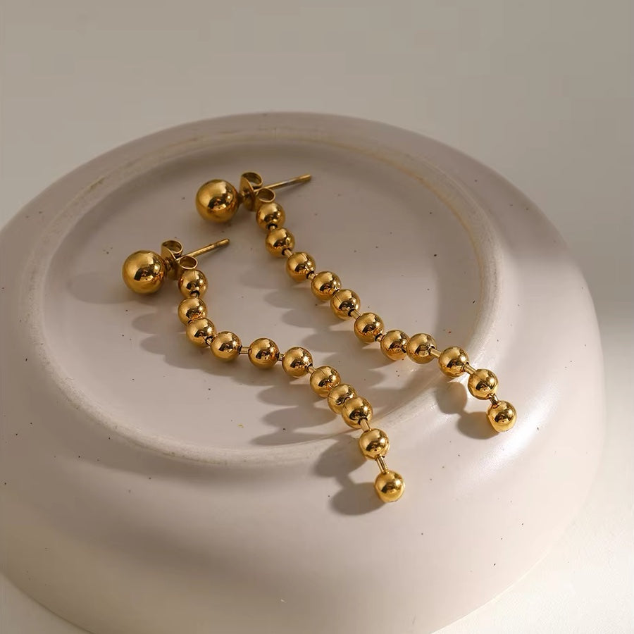 Boucles d'oreilles pompons perles dorées