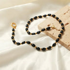 Collier bohème perles noires et fermoir doré