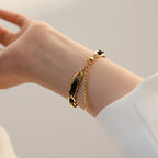 Bracelet en cuir tressé, chaîne dorée et noire