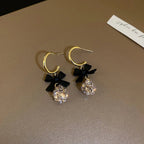 Boucles d'oreilles pendantes nœud et diamant