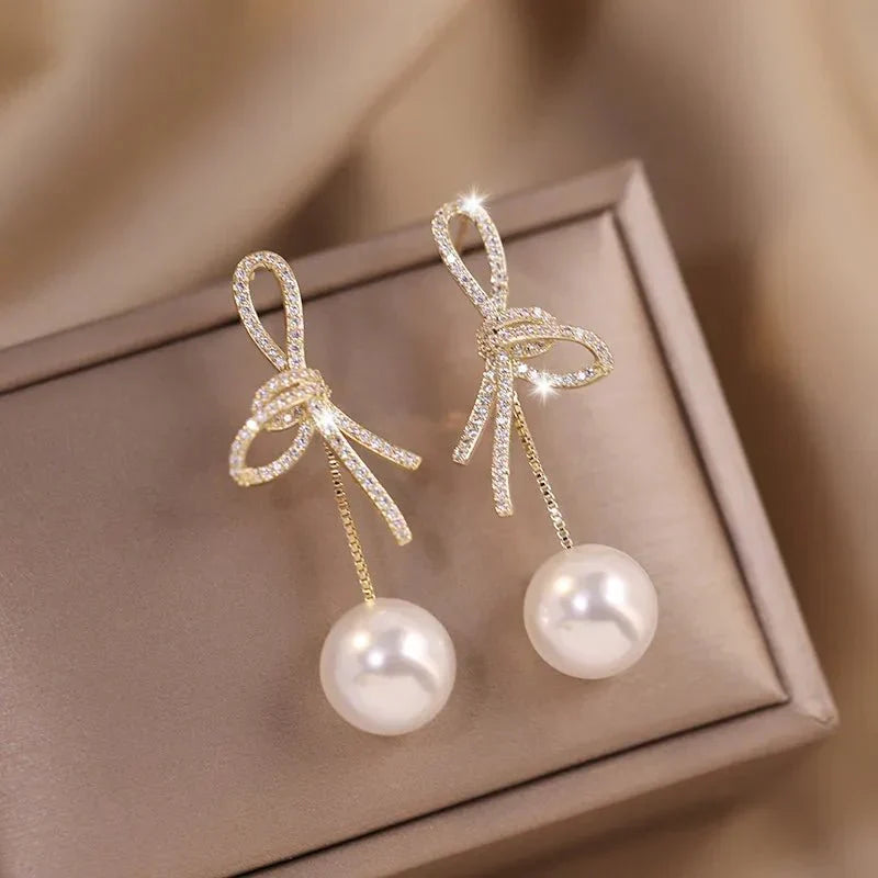 Boucles d'oreilles pendantes nœud et perle