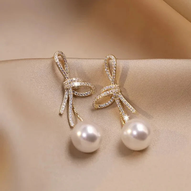 Boucles d'oreilles pendantes nœud et perle